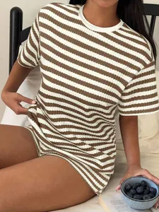 Macro detail view of a brown and white striped loose casual T-shirt for summer leisure wear