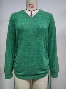 Casual loose green V-neck long sleeve T-shirt featuring drawstring side details on a mannequin