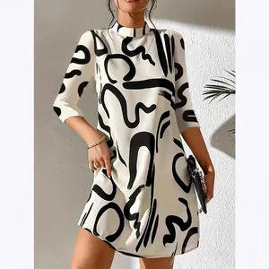 Chic A-line mini dress with a bold black abstract brushstroke print on cream base