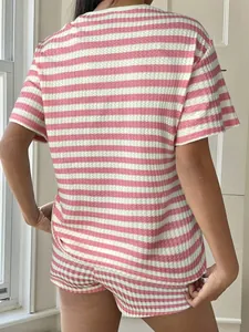 Women's summer pink and white striped waffle-knit pajama set shown from the back
