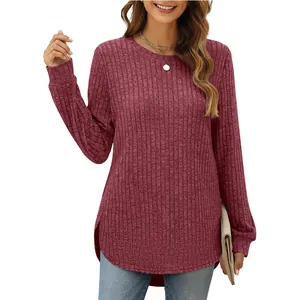 Detail of maroon ribbed long sleeve top featuring a high-low curved hemline