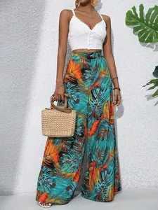 Full body view of vibrant tropical palm leaf print wide-leg trousers with crop top