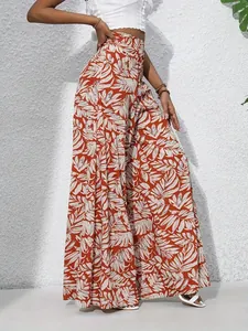 Elegant summer high-waisted wide-leg pants featuring a vibrant tropical leaf print design