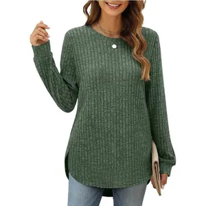 Detail of women's loose green ribbed long sleeve top with curved hem and round neck