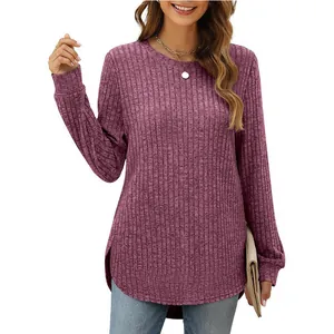 Detail view of women's loose round neck long sleeve top with curved high-low hem