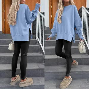 Detail view of oversized light blue sweatshirt featuring side slits and batwing sleeves