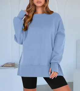 Detail of blue loose-fit sweatshirt with side slits and batwing sleeves