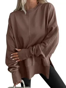 Macro view of brown oversized sweatshirt featuring ribbed cuffs and side slit detail