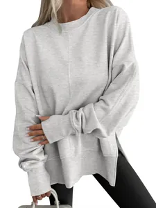 Detail view of grey oversized crew neck sweatshirt with side slits and batwing sleeves