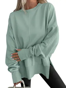 Detailed view of mint green oversized sweatshirt with side slits and batwing sleeves.