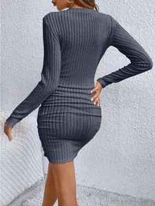 Rear view showing the texture of a charcoal grey ribbed long-sleeved bodycon dress
