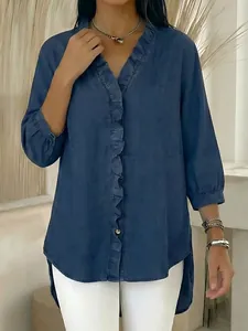Detail view of denim-look V-neck blouse with elegant ruffle trim on the front placket
