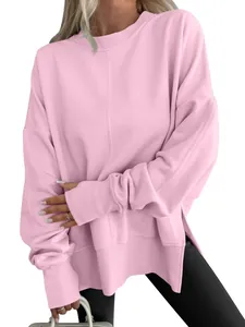 Close-up of pink oversized round neck sweatshirt with side splits and batwing sleeves