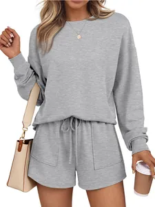 Set due pezzi casual da donna con maglia grigia a maniche lunghe e pantaloncini coordinati.
