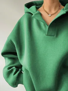 Detailed view of women's green oversized hoodie featuring unique collar design and soft texture