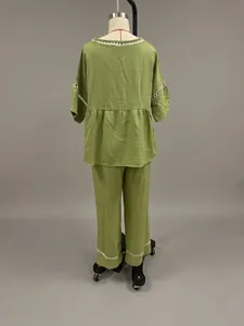 Rear view of green loose-fit imitation linen two-piece set with embroidery details