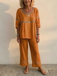 Casual women's two-piece linen set featuring decorative cut-out trim and relaxed fit