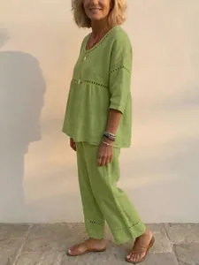 Women's loose green linen-like two-piece set featuring elegant eyelet lace detailing
