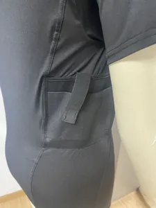 Close-up of side concealed tactical holster pocket on high-elastic black t-shirt