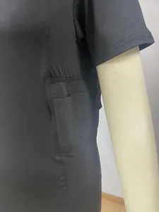 Macro view showing the side concealed holster detail on a black tactical T-shirt
