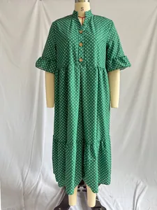 Green polka dot V-neck dress featuring feminine ruffle sleeves and a tiered midi skirt
