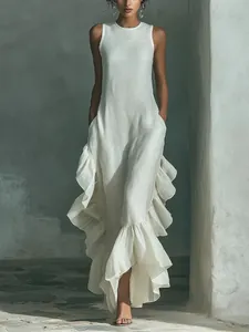 Close-up of elegant sleeveless white maxi dress with dramatic side and hem ruffles