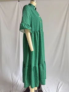 Side view of a green polka dot midi dress with ruffle sleeves on a mannequin.