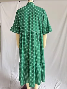 Back view of a green bohemian polka dot maxi dress featuring ruffle sleeves and tiered skirt