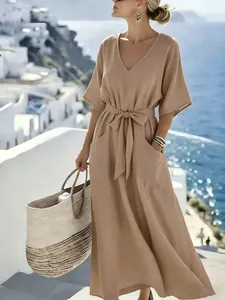 Close-up detail of a beige short sleeve vacation maxi dress with a tie belt and pockets.