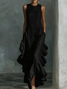 Detailed macro view of the ruffled hem and textured fabric of an elegant black maxi dress.