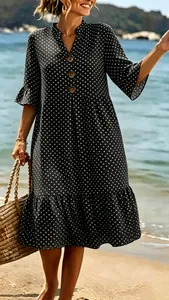 Close-up of a black V-neck polka dot Bohemian dress with wooden buttons and ruffles.