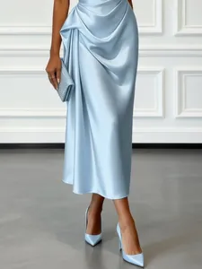 Detailed view of the elegant light blue satin dress featuring sophisticated draping.