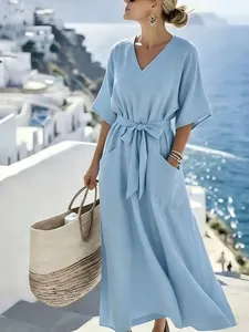 Elegant light blue V-neck maxi dress with waist-tie detail and convenient side pockets