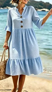 Close-up of a blue polka dot bohemian dress with V-neck and ruffle sleeves on beach