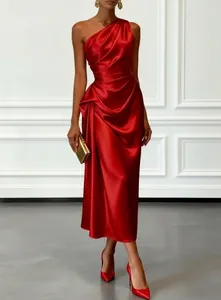 Detailed close-up showing the draped satin texture of a red one-shoulder evening gown