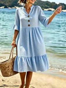 Light blue V-neck polka dot Bohemian midi dress with ruffle sleeves shown on a beach