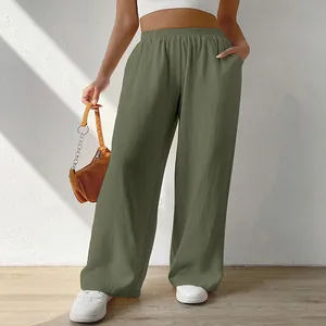 Close-up detail of stylish green wide-leg casual pants with pockets and elastic waist