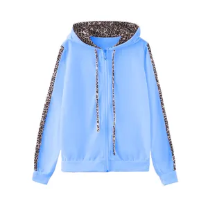 Dettaglio di una felpa azzurra con zip e inserti leopardati su cappuccio e maniche