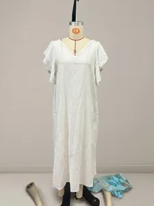 Full length view of a white cotton linen dress with flutter sleeves on mannequin