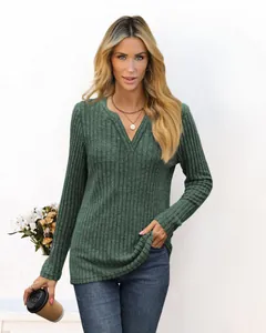 Modern woman wearing dark green ribbed V-neck long sleeve t-shirt in a stylish casual pose