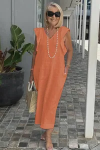 Casual orange cotton linen maxi dress with ruffle sleeves shown in an outdoor setting.