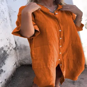 Detailed view of a vibrant loose orange linen cotton button-down shirt dress for women.