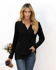 Detailed macro view of women's black ribbed knit long-sleeved top with elegant V-neckline