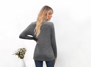 Back view of a casual grey ribbed long-sleeve T-shirt for women in a minimalist setting