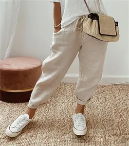 Casual beige linen cropped trousers with elastic drawstring waist for women.