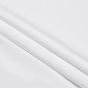 Vista macro della trama fine del tessuto bianco e delle pieghe morbide del set due pezzi