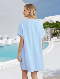 Back view of light blue v-neck beach dress showing crinkle texture in resort setting.