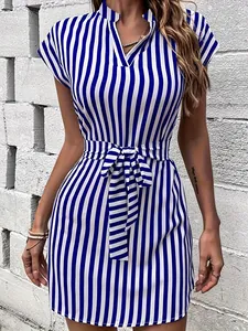 Detailed view of elegant blue and white vertical striped dress with stylish waist tie