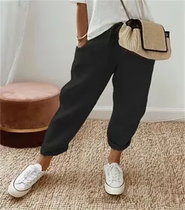 Close-up detail of women's black cotton linen elastic waist cropped casual pants with pockets.