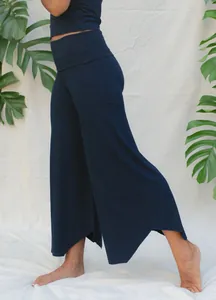 Side view of navy blue high-waisted wide-leg yoga pants with asymmetrical hem
